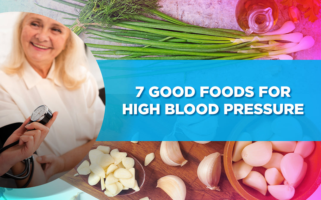 Senior woman smiling, holding a blood pressure monitor; garlic, onions, and greens in the background.