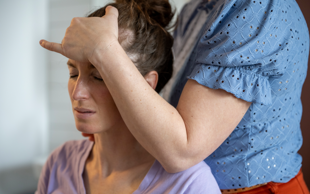 Woman with stiff neck at Chiropractor