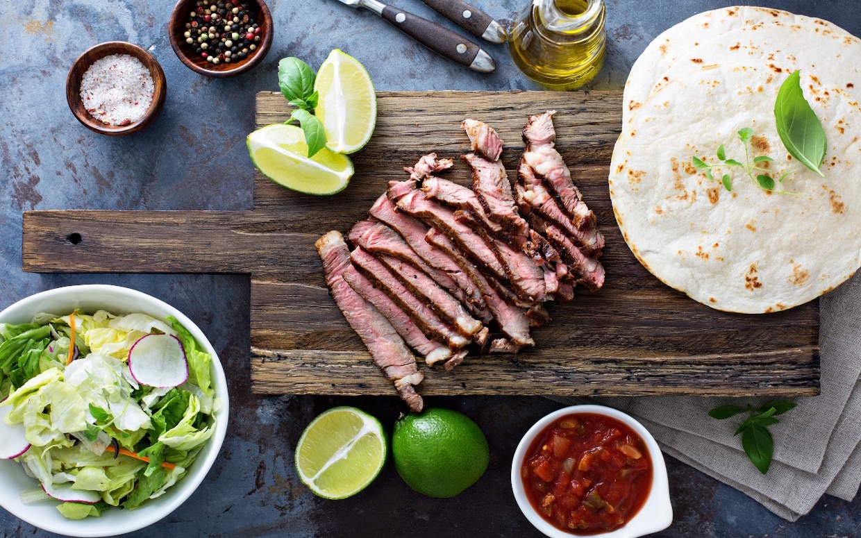 Cooking steak tacos with sliced meat