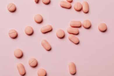 pink pills on a pink table
